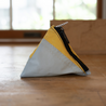 A small pyramid shaped pouch made from upcycled blue and yellow sailboat sail