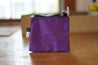 A small purple rectangle pouch made from upcycled sailboat sail