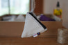 A small pyramid shaped pouch made from white upcycled sailboat sail